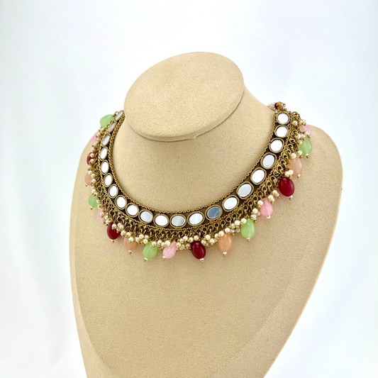 Mirror necklace set with multi colour beads and small white pearls. Set includes necklace, tikka and earrings. Prefect for Indian parties, weddings and special occasions. Latest 2022 fashion.