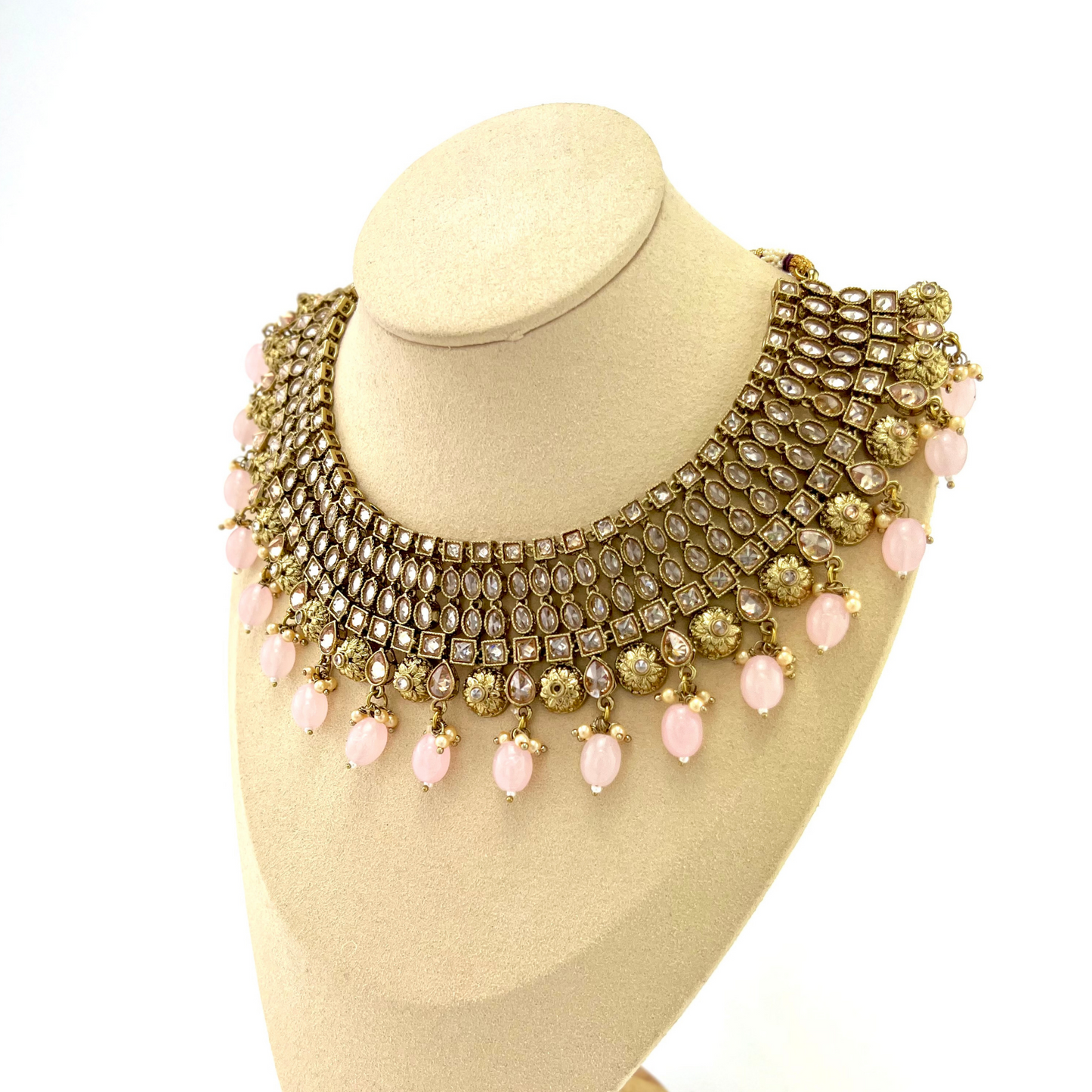Necklace set with pink beads and gold stone work. Set includes necklace, tikka and earrings. Prefect for Indian weddings, parties and special occasions. Latest 2022 fashion. High end Indian fashion jewellery with top quality stones and beads.