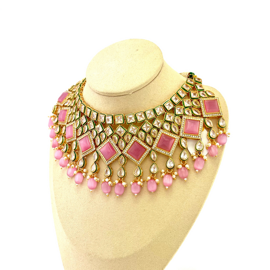 Necklace set with pink beads and pink and clear stone. Set includes necklace, tikka & earrings. Prefect for Indian weddings, parties and special occasions. Latest 2022 fashion. High end Indian fashion jewellery with top quality stones and beads.