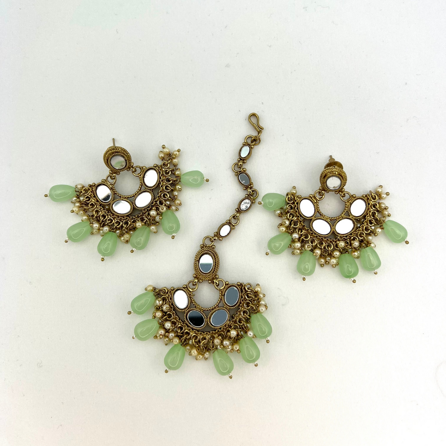Mirror necklace set with green beads and small white pearls. Set includes necklace, tikka and earrings. Prefect for Indian parties, weddings and special occasions. Latest 2022 fashion.