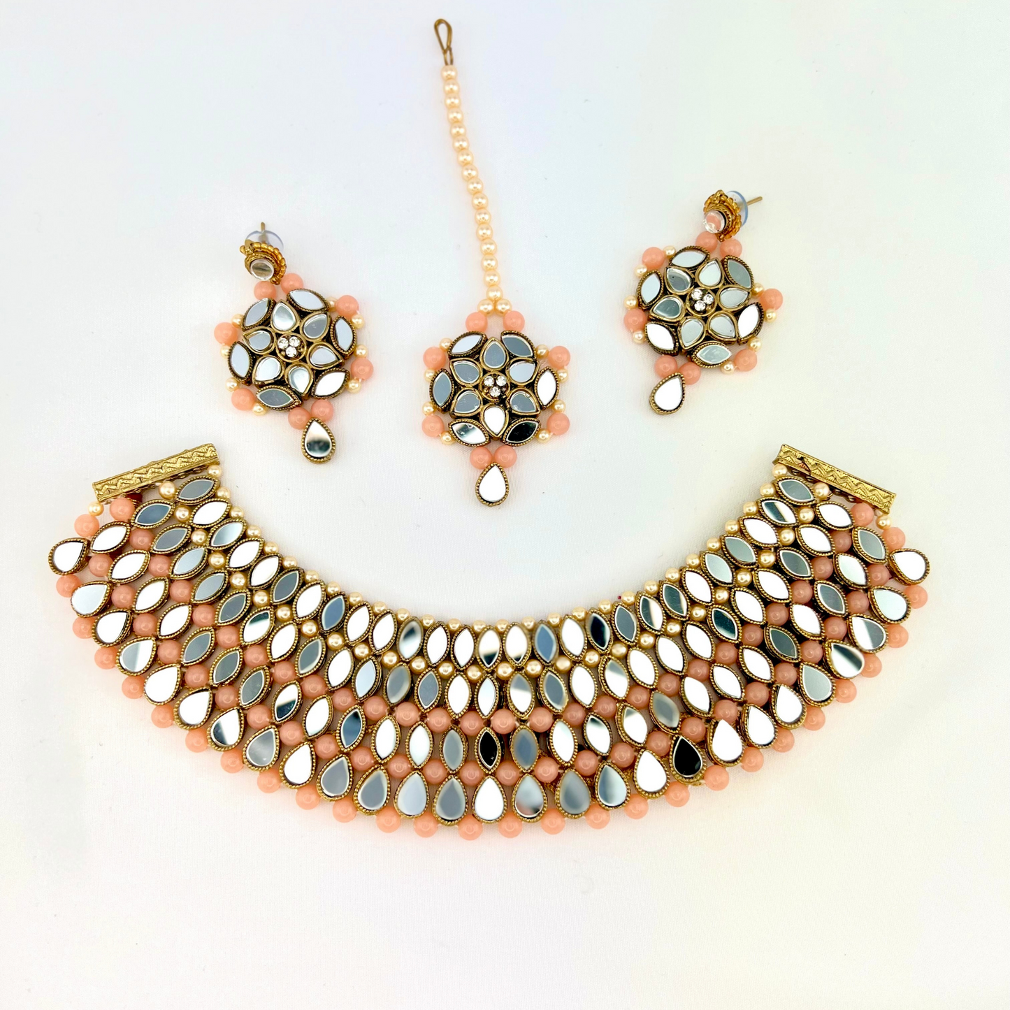 Mirror necklace set with pink beads, clear stones and pearls. Set includes, necklace, tikka and earrings. Prefect for Indian weddings, parties and special occasions. Latest 2022 fashion. High end Indian fashion jewellery with top quality stones and beads.