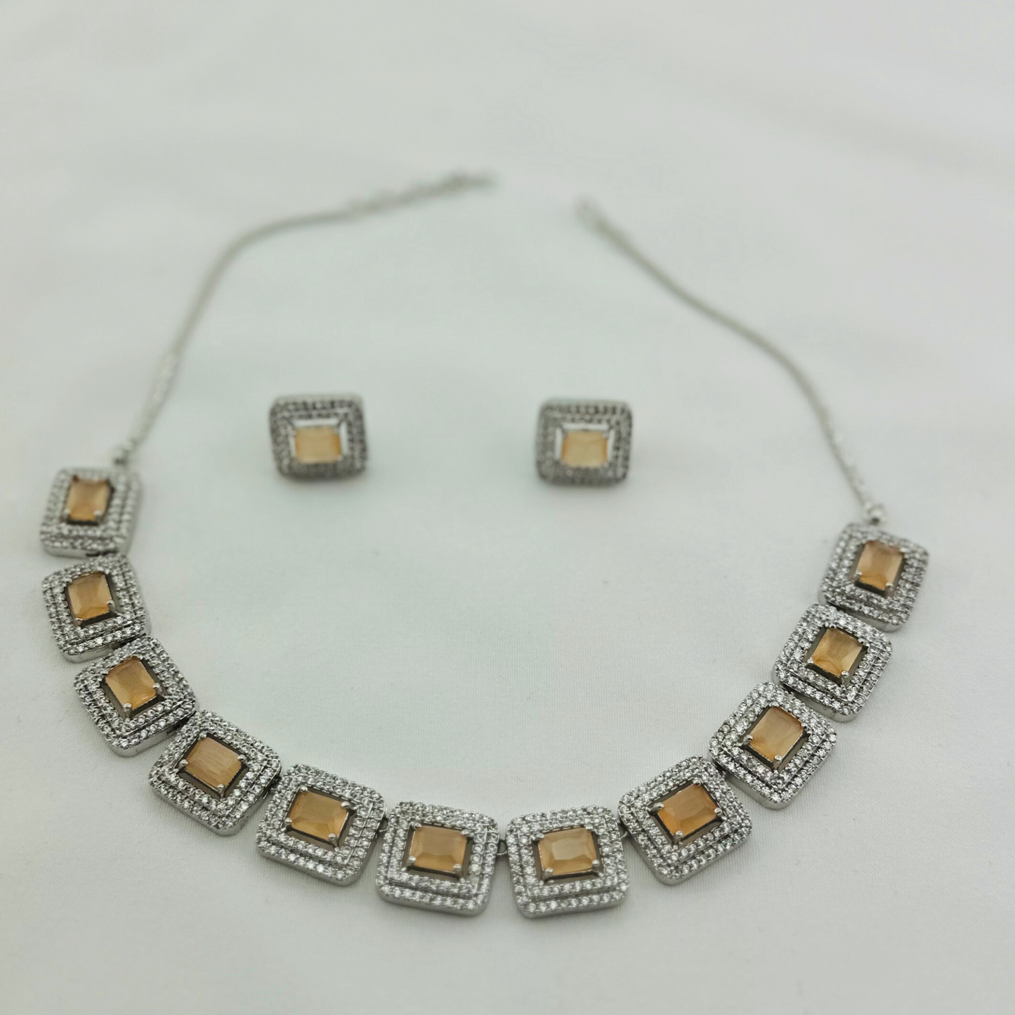 Necklace set with peach and clear stones. Set includes necklace & earrings. Prefect for Indian weddings, parties and special occasions. Latest 2023 fashion. High end Indian fashion jewellery with top quality stones and beads.