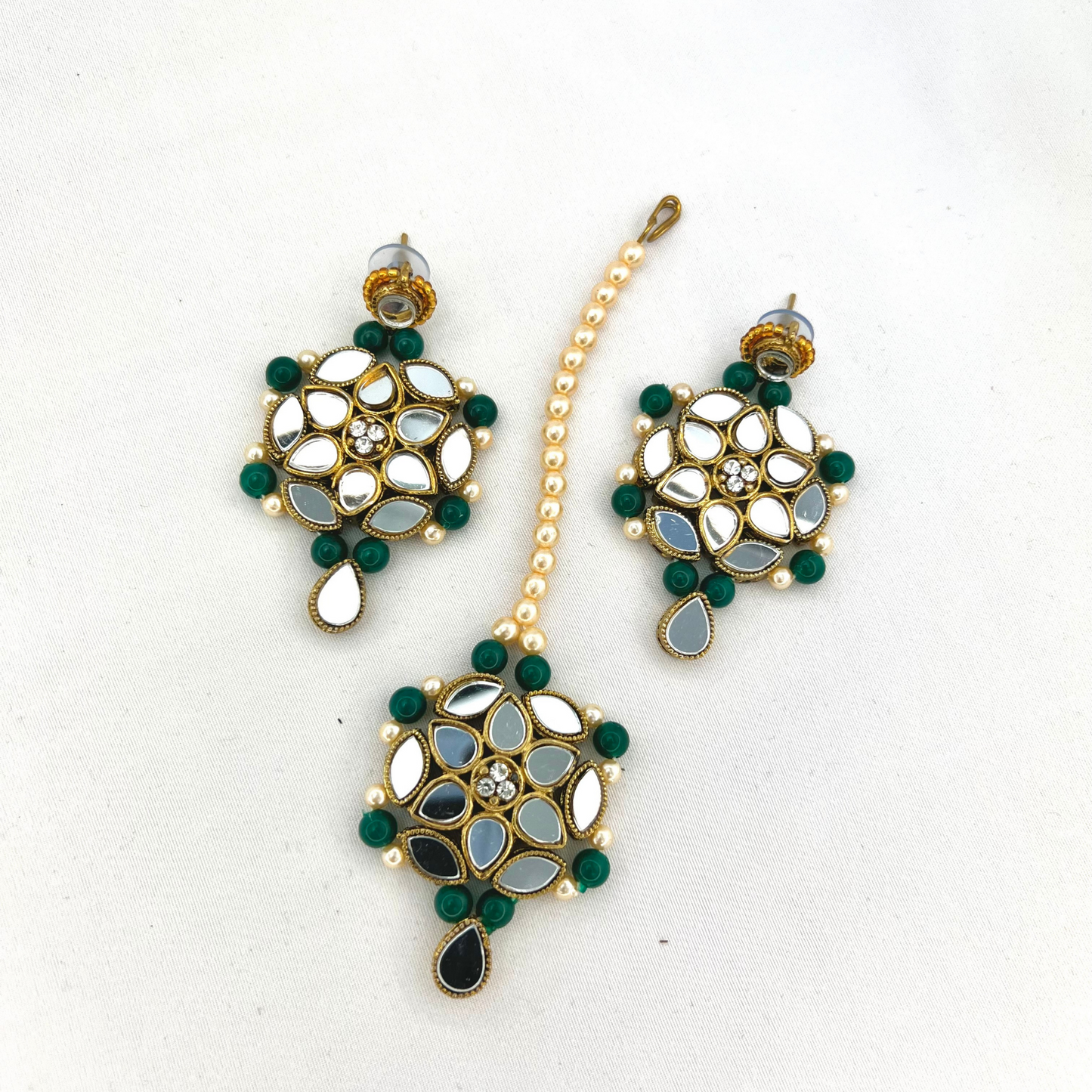 Mirror necklace set with forest green beads, clear stones and pearls. Set includes, necklace, tikka and earrings. Prefect for Indian weddings, parties and special occasions. Latest 2022 fashion. High end Indian fashion jewellery with top quality stones and beads.