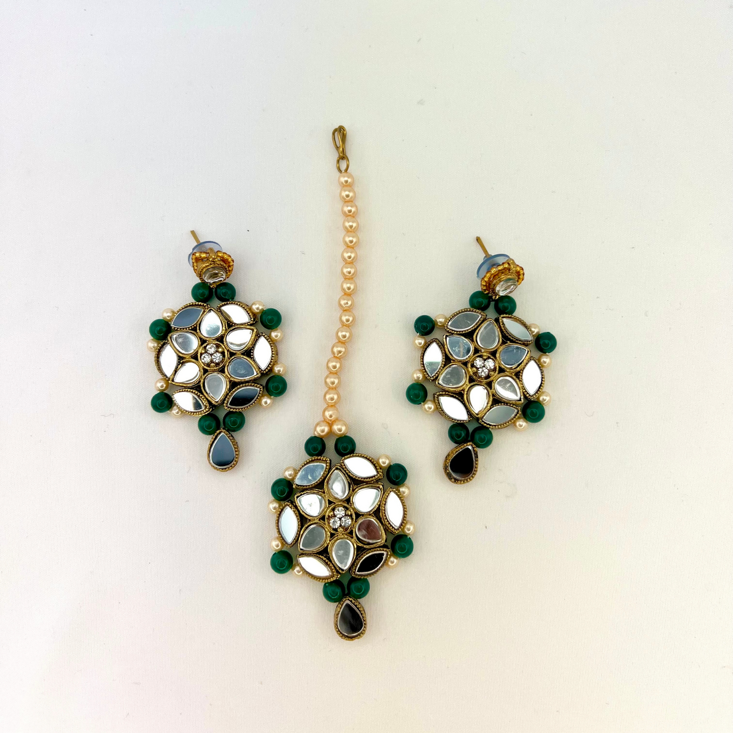 Mirror necklace set with forest green beads, clear stones and pearls. Set includes, necklace, tikka and earrings. Prefect for Indian weddings, parties and special occasions. Latest 2022 fashion. High end Indian fashion jewellery with top quality stones and beads.