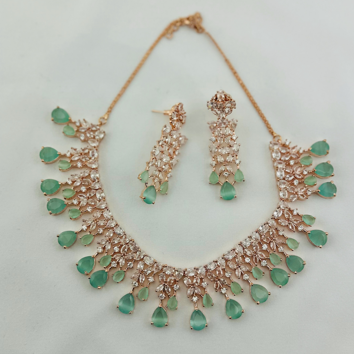 Rosegold necklace set with light blue and clear stones. Set includes necklace & earrings. Prefect for Indian weddings, parties and special occasions. Latest 2023 fashion. High end Indian fashion jewellery with top quality stones and beads.