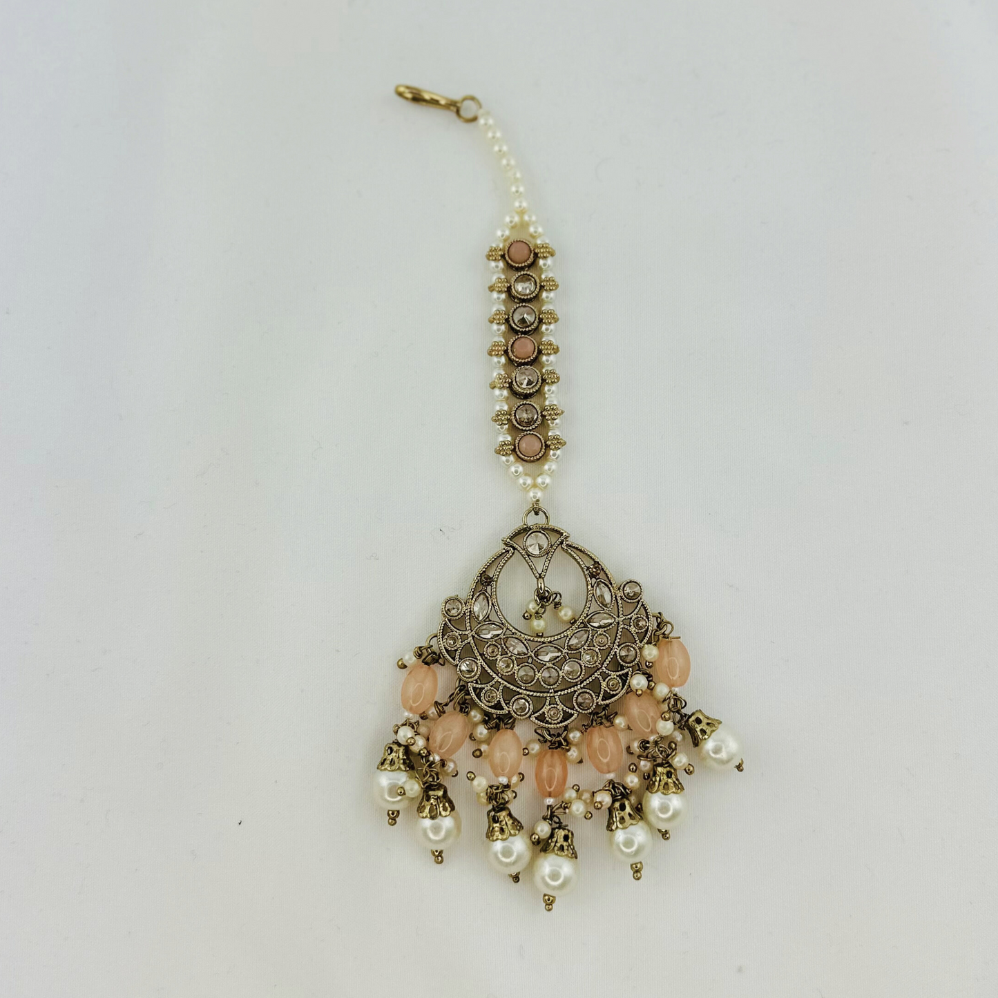 Necklace set with peach stones and white pearl beads. Set includes necklace, tikka & earrings. Prefect for Indian weddings, parties and special occasions. Latest 2023 fashion. High end Indian fashion jewellery with top quality stones and beads.