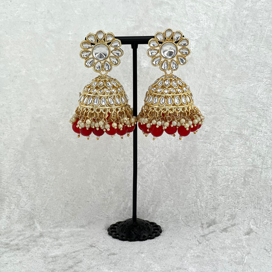 Jhumka earrings in red with stones, pearls and beads. Indian wedding jewellery prefect for weddings, parties and special occasions. latest high quality 2022 fashion