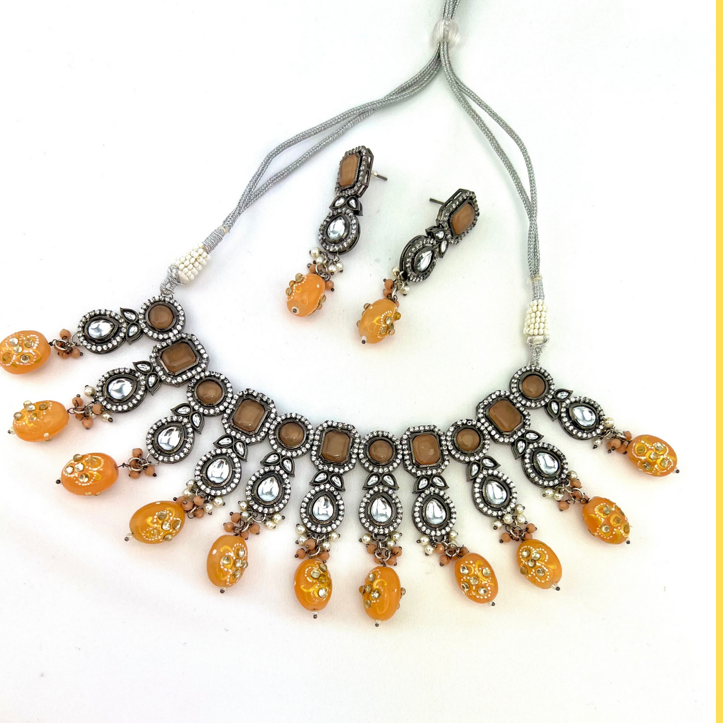 Kundan necklace set with peach and clear stone work. Set includes necklace and earrings. Prefect for Indian weddings, parties and special occasions. Latest 2022 fashion. High end Indian fashion jewellery with top quality stones and beads.