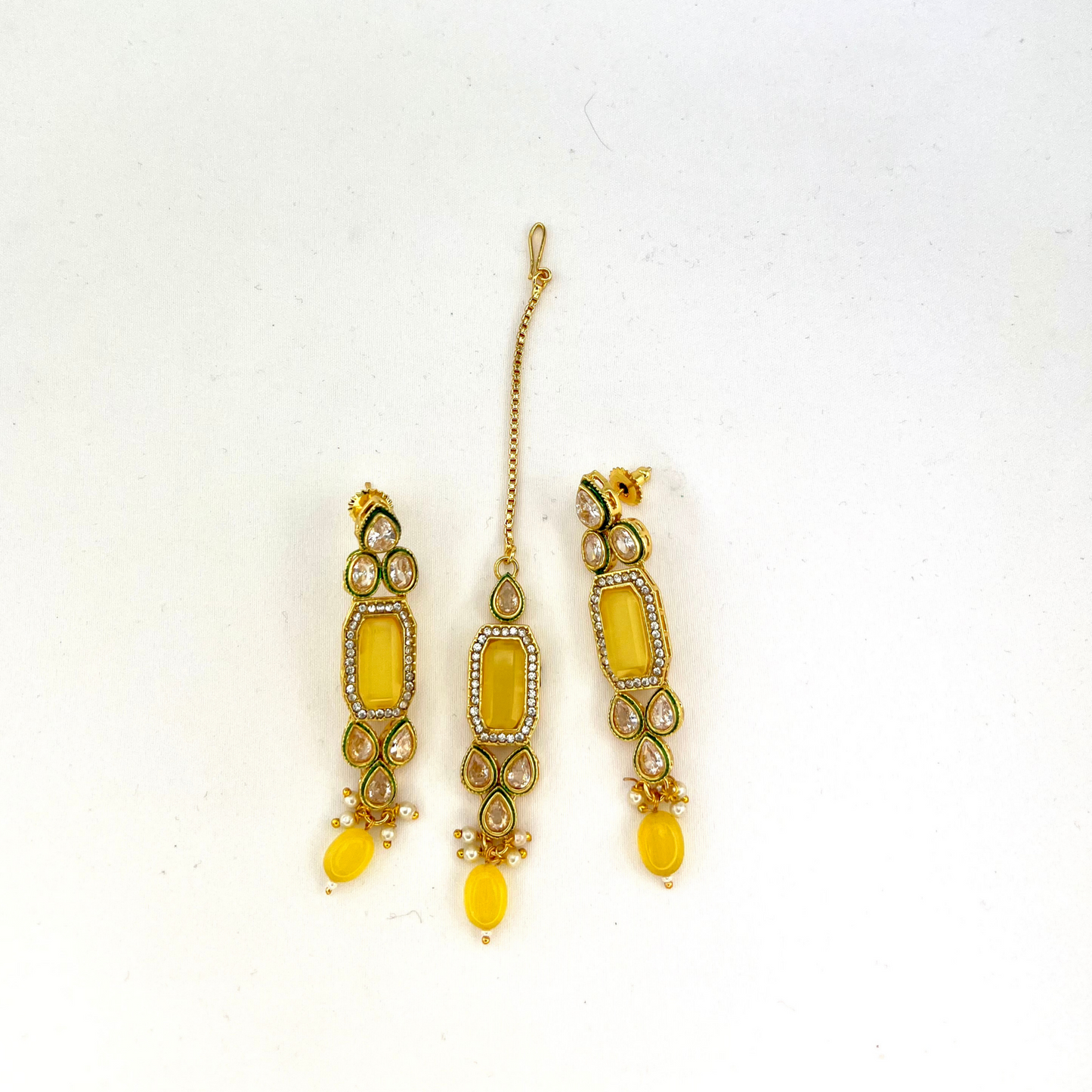 Necklace set with yellow beads and clear and yellow stones. Set includes necklace, tikka and earrings. Prefect for Indian weddings, parties and special occasions. Latest 2022 fashion. High end Indian fashion jewellery with top quality stones and beads.