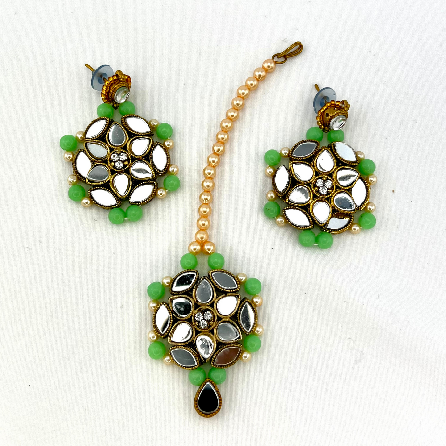 Mirror necklace set with green beads, clear stones and pearls. Set includes, necklace, tikka and earrings. Prefect for Indian weddings, parties and special occasions. Latest 2022 fashion. High end Indian fashion jewellery with top quality stones and beads.