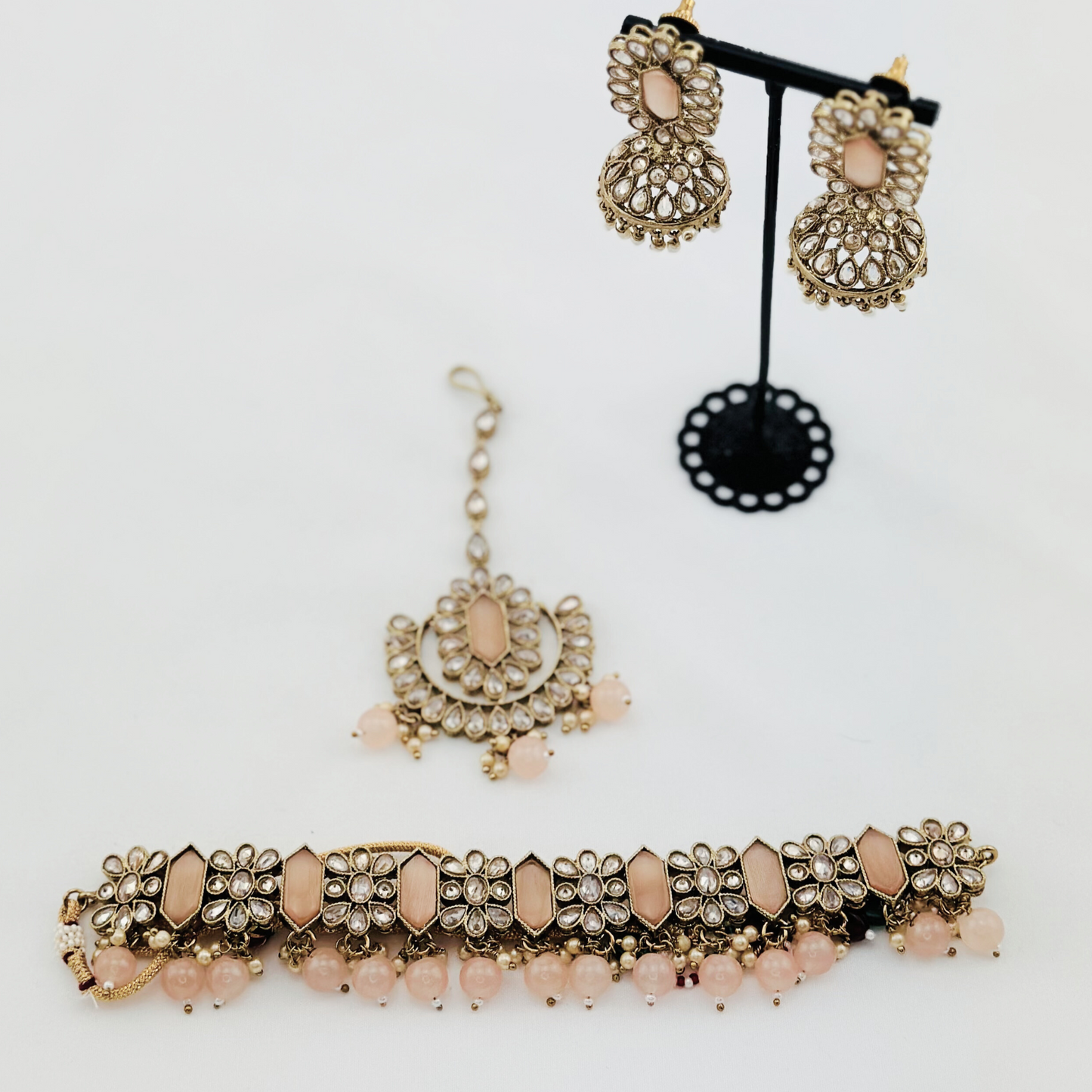 Choker set with baby pink beads and stones. Set includes necklace, tikka & earrings. Prefect for Indian weddings, parties and special occasions. Latest 2023 fashion. High end Indian fashion jewellery with top quality stones and beads.