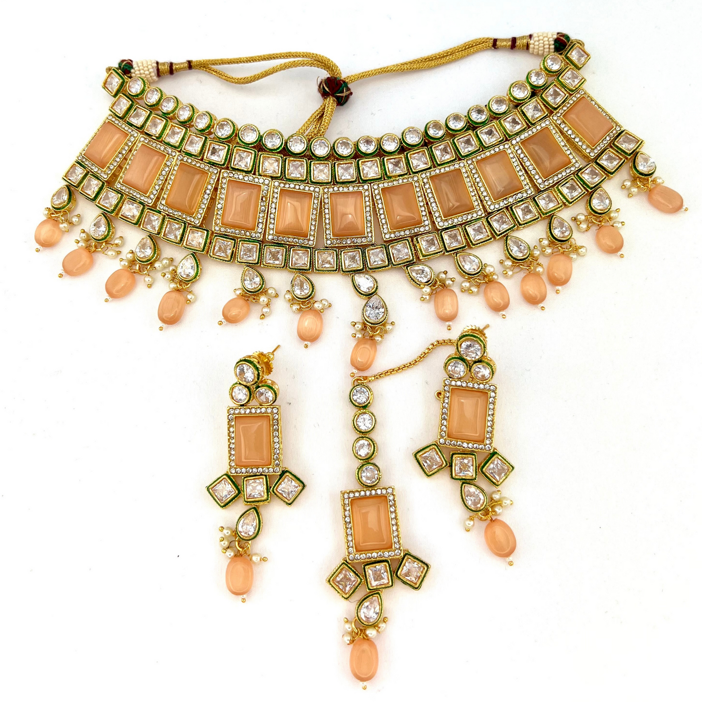 Necklace set with peach and clear stones and peach beads. Set includes necklace, tikka and earrings. Prefect for Indian weddings, parties and special occasions. Latest 2022 fashion. High end Indian fashion jewellery with top quality stones and beads.
