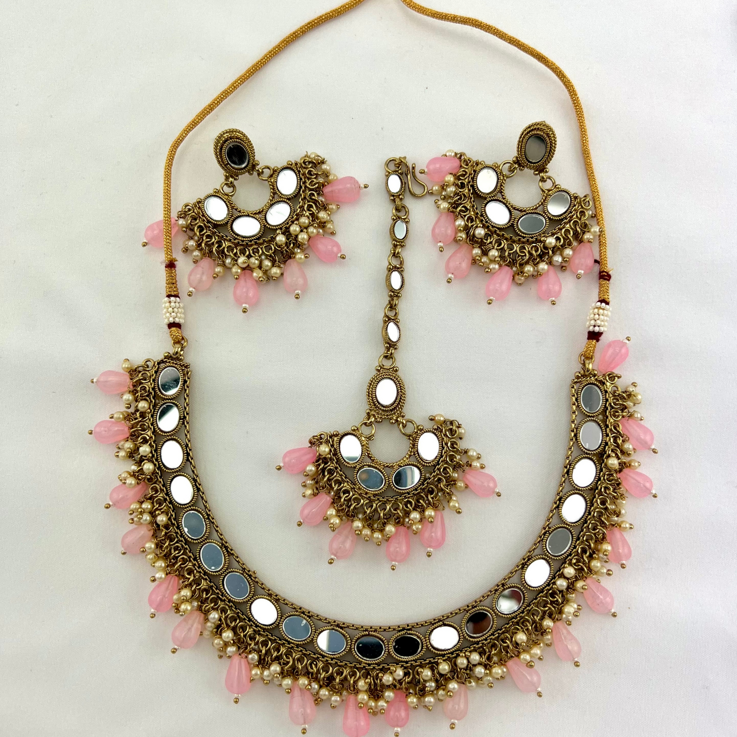 Mirror necklace set with pink beads and small white pearls. Set includes necklace, tikka and earrings. Prefect for Indian parties, weddings and special occasions. Latest 2022 fashion.