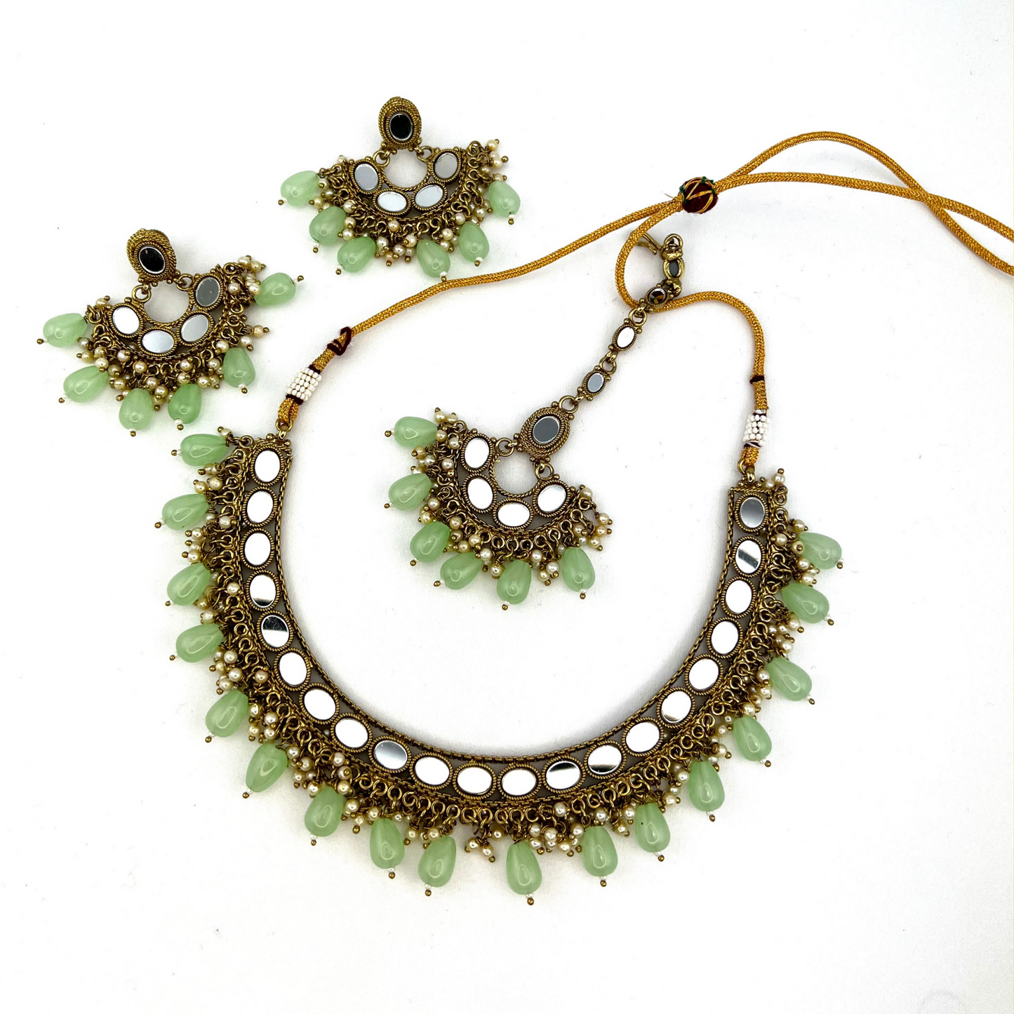 Mirror necklace set with green beads and small white pearls. Set includes necklace, tikka and earrings. Prefect for Indian parties, weddings and special occasions. Latest 2022 fashion.
