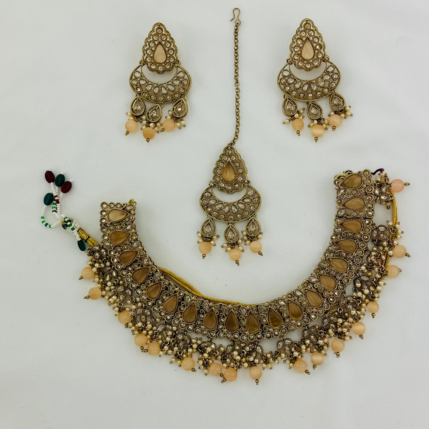 Necklace set with peach beads and stone. Set includes necklace, tikka & earrings. Prefect for Indian weddings, parties and special occasions. Latest 2023 fashion. High end Indian fashion jewellery with top quality stones and beads.