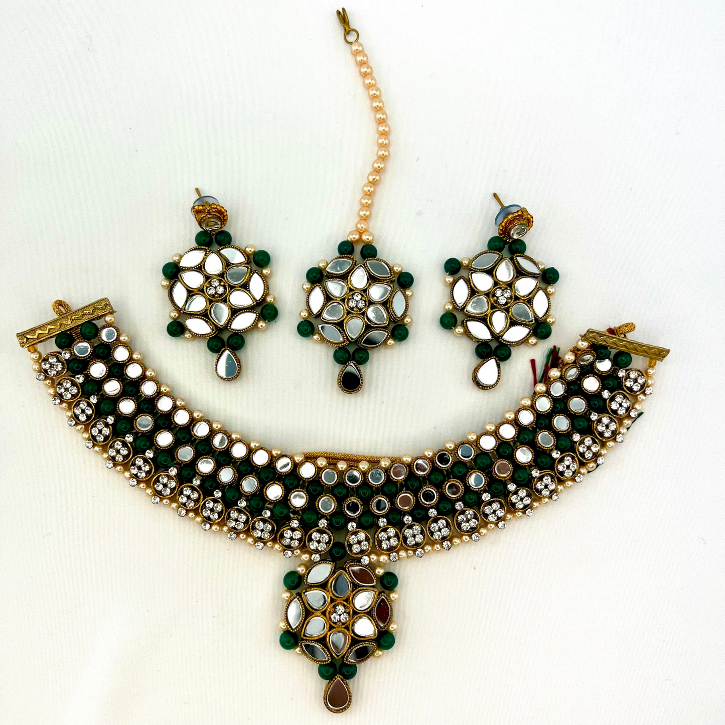 Mirror necklace set with forest green beads, clear stones and pearls. Set includes, necklace, tikka and earrings. Prefect for Indian weddings, parties and special occasions. Latest 2022 fashion. High end Indian fashion jewellery with top quality stones and beads.