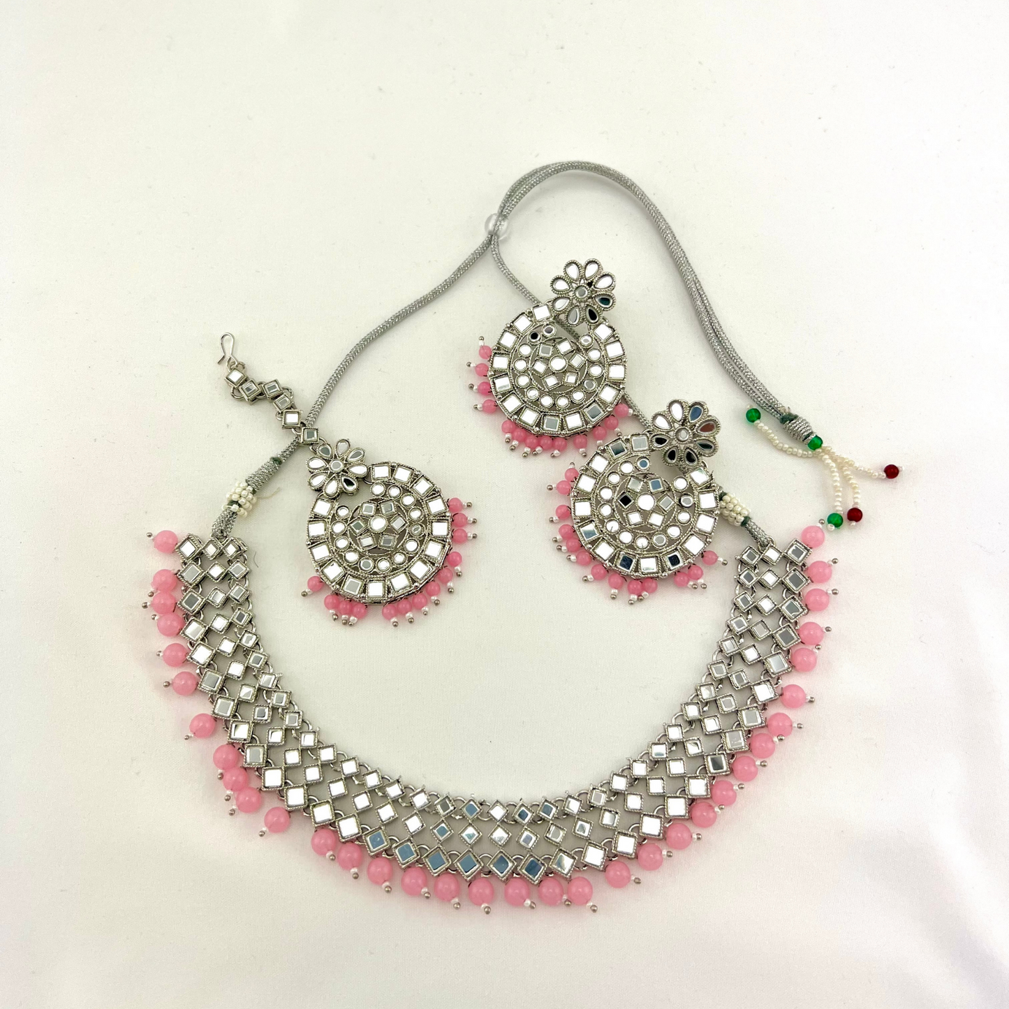 Mirror necklace set with baby pink beads. Set includes, necklace, tikka and earrings. Prefect for Indian weddings, parties and special occasions. Latest 2022 fashion. High end Indian fashion jewellery with top quality stones and beads.