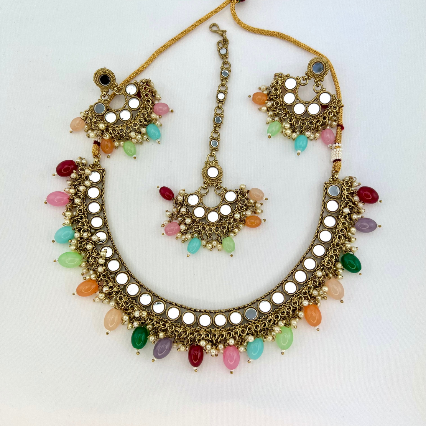 Mirror necklace set with multi colour beads and small pearls. Set includes necklace, tikka and earrings. Prefect for Indian parties, weddings and special occasions. Latest 2022 fashion