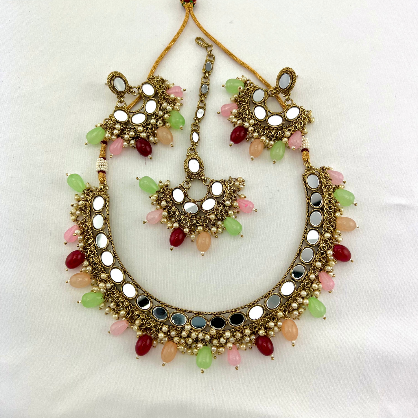 Mirror necklace set with multi colour beads and small white pearls. Set includes necklace, tikka and earrings. Prefect for Indian parties, weddings and special occasions. Latest 2022 fashion.