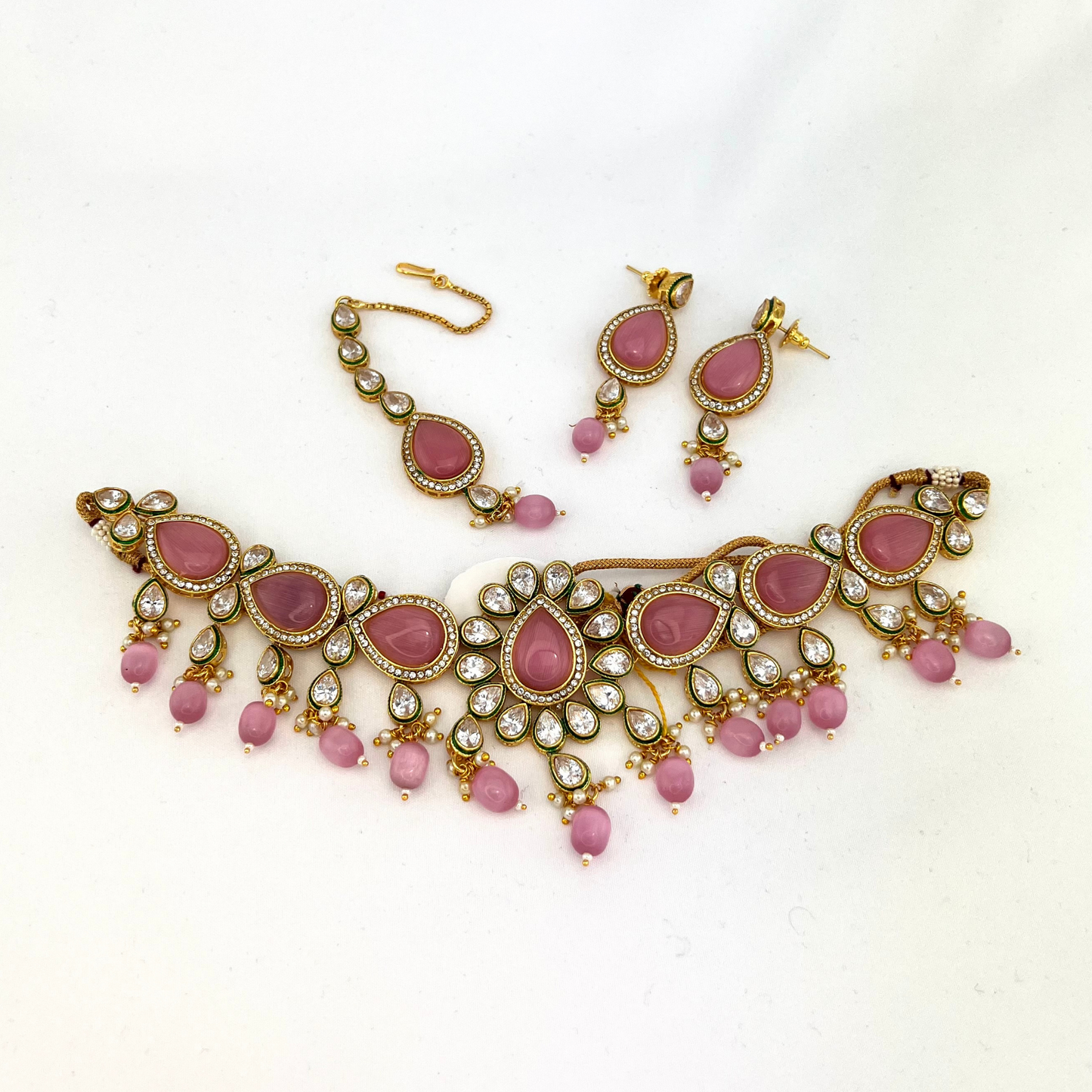 Choker set with pink, clear stones and pink beads. Set includes choker, tikka and earrings. Prefect for Indian weddings, parties and special occasions. Latest 2022 fashion. High end Indian fashion jewellery with top quality stones and beads.