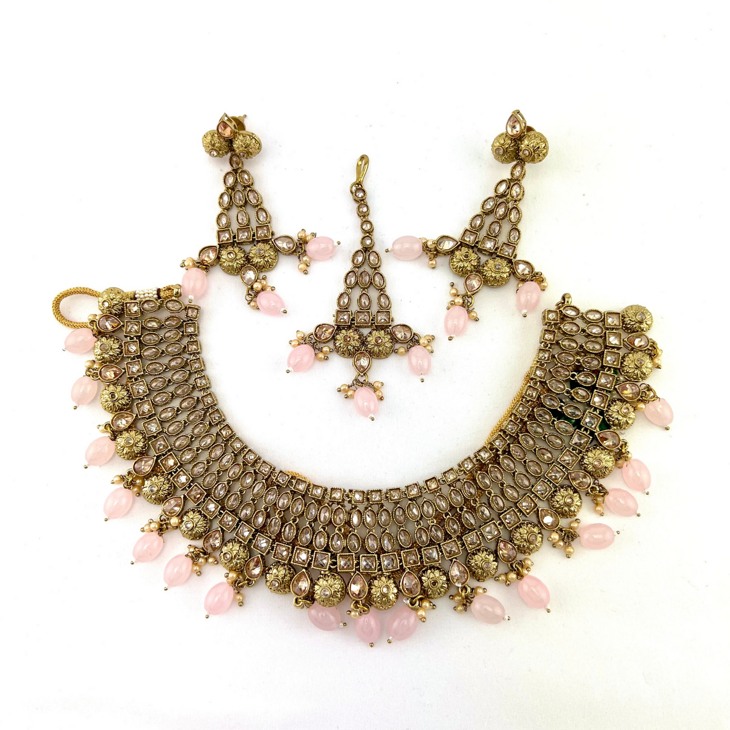 Necklace set with pink beads and gold stone work. Set includes necklace, tikka and earrings. Prefect for Indian weddings, parties and special occasions. Latest 2022 fashion. High end Indian fashion jewellery with top quality stones and beads.