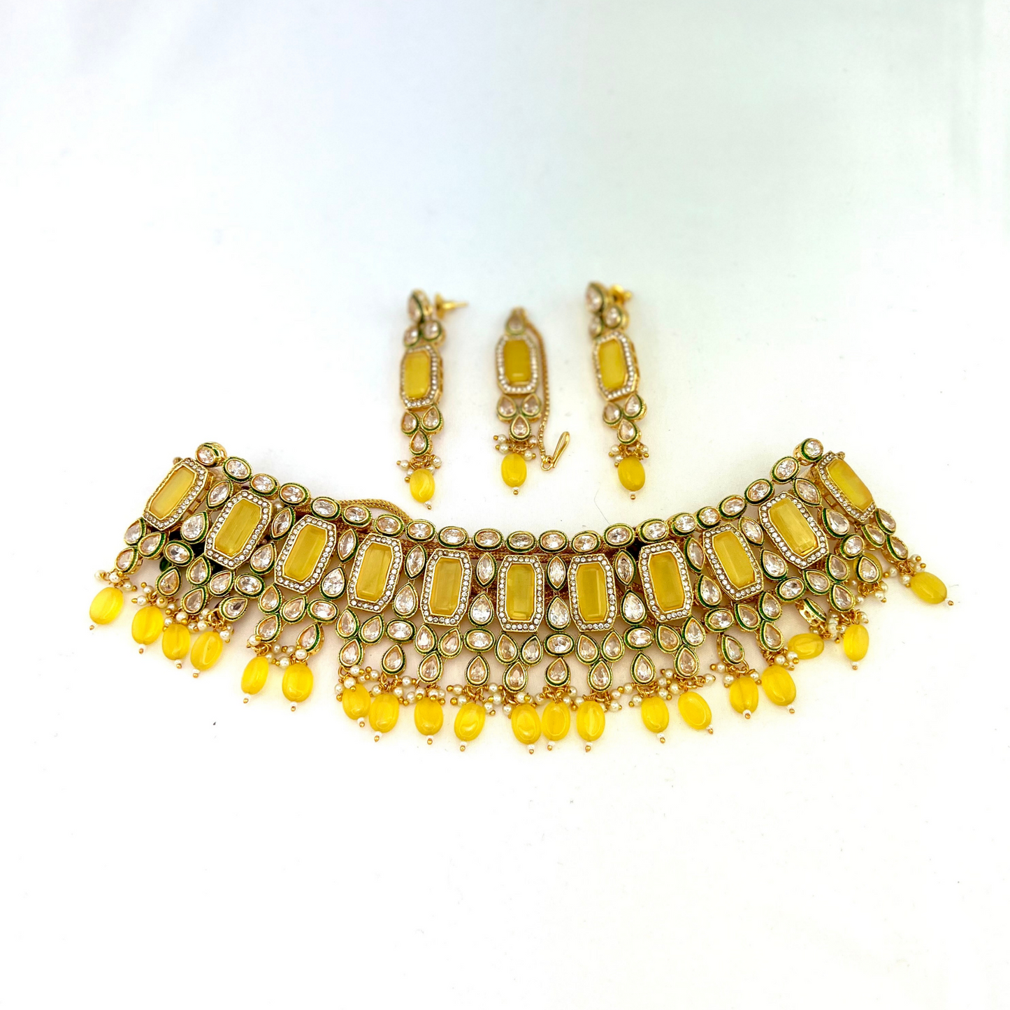 Necklace set with yellow beads and clear and yellow stones. Set includes necklace, tikka and earrings. Prefect for Indian weddings, parties and special occasions. Latest 2022 fashion. High end Indian fashion jewellery with top quality stones and beads.