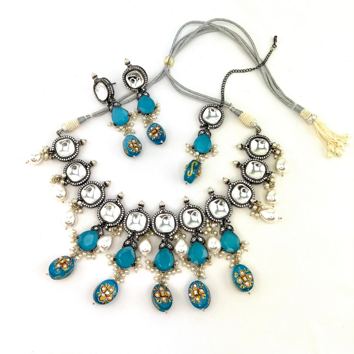 Kundan necklace set with with clear and blue stones. Set includes necklace, tikka and earrings. Prefect for Indian weddings, parties and special occasions. Latest 2022 fashion. High end Indian fashion jewellery with top quality stones and beads.