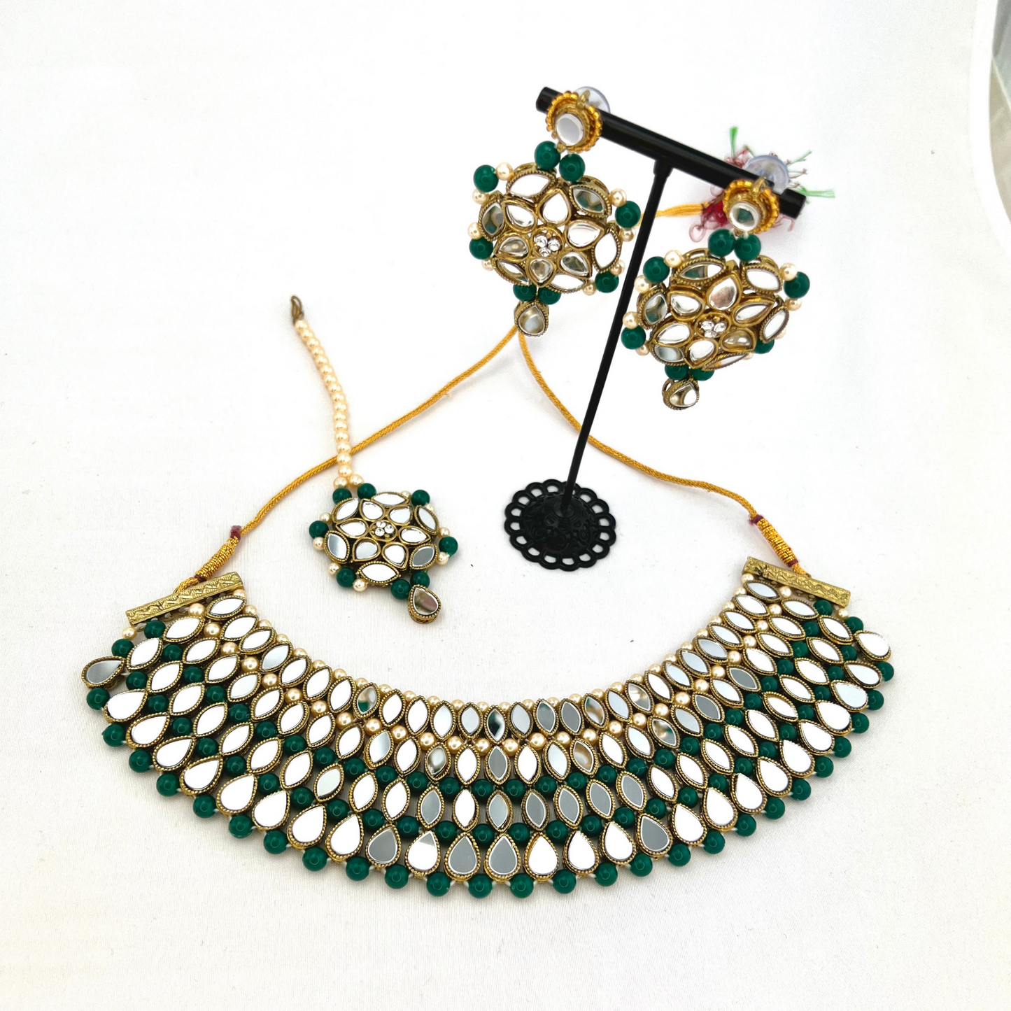 Mirror necklace set with forest green beads, clear stones and pearls. Set includes, necklace, tikka and earrings. Prefect for Indian weddings, parties and special occasions. Latest 2022 fashion. High end Indian fashion jewellery with top quality stones and beads.