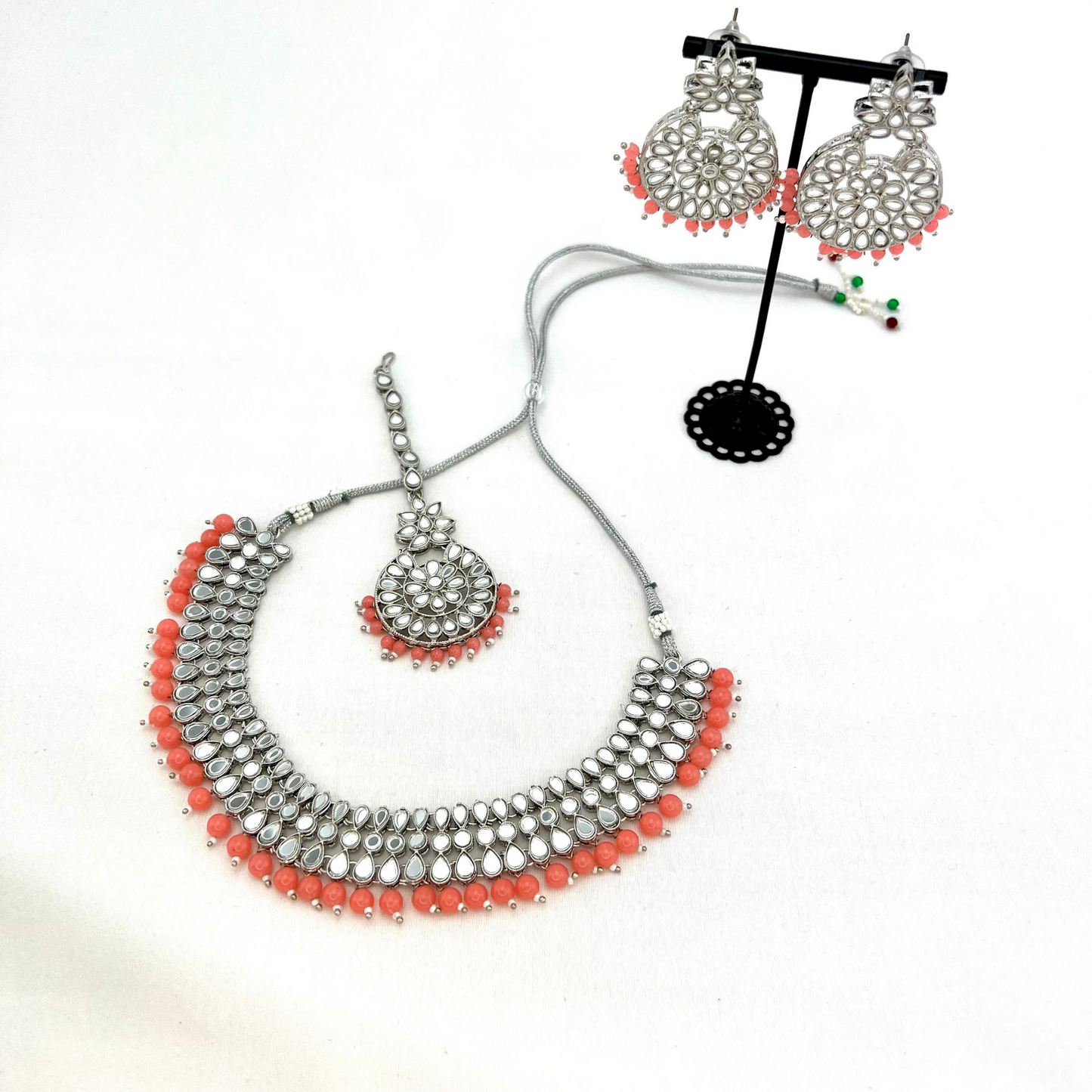 Mirror necklace set with pink beads. Set includes, necklace, tikka and earrings. Prefect for Indian weddings, parties and special occasions. Latest 2022 fashion. High end Indian fashion jewellery with top quality stones and beads.