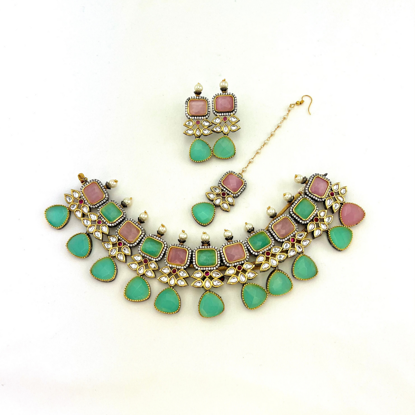 Necklace set with green, pink and silver stone work finished with small white pearls. Set includes necklace, tikka and earrings. Prefect for Indian parties, weddings and special occasions. Latest 2022 fashion