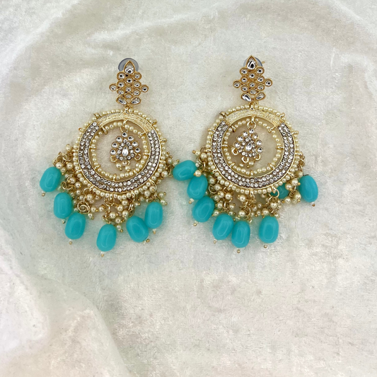 Indian wedding jewellery, earrings in baby blue with pearls, stones and beads. latest 2022 fashion for indian weddings, parties and special occasion