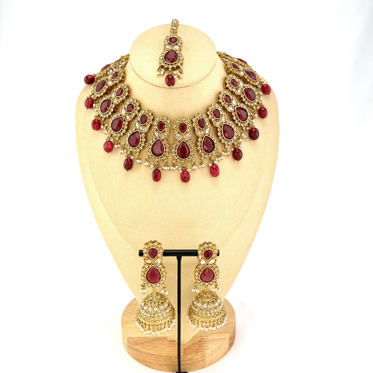 ﻿Necklace set with maroon and gold stone work and maroon beads.  Set includes necklace, tikka and earrings.  Prefect for Indian weddings, parties and special occasions.  Latest 2022 fashion. High end Indian fashion jewellery with top quality stones and beads.