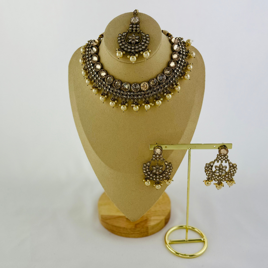 Necklace set with white pearl beads.  Set includes necklace, tikka & earrings.  Prefect for Indian weddings, parties and special occasions.   Latest 2023 fashion. High end Indian fashion jewellery with top quality stones and beads.