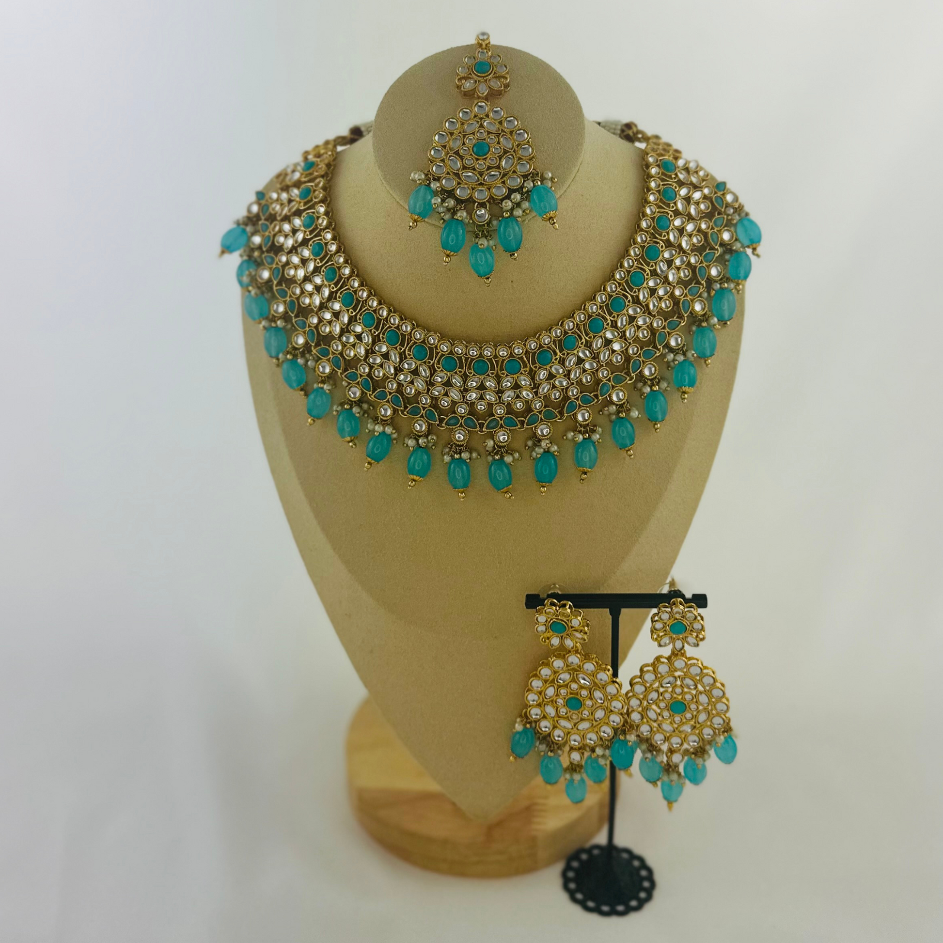 Necklace set with turquoise stones and beads.  Set includes necklace, tikka & earrings.  Prefect for Indian weddings, parties and special occasions.   Latest 2023 fashion. High end Indian fashion jewellery with top quality stones and beads.