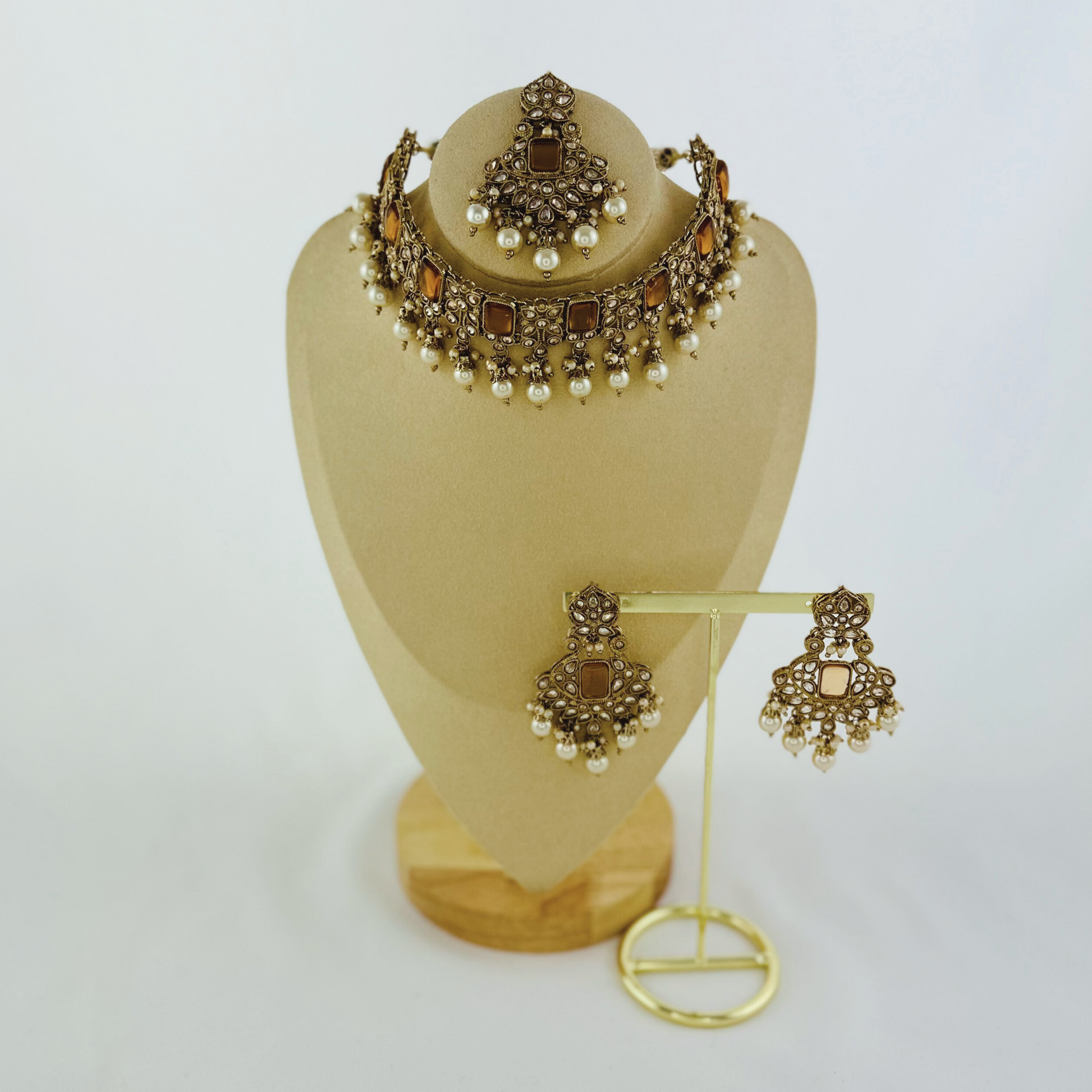 Choker set with white bead and bronze stones.  Set includes necklace, tikka & earrings.  Prefect for Indian weddings, parties and special occasions.   Latest 2023 fashion. High end Indian fashion jewellery with top quality stones and beads.