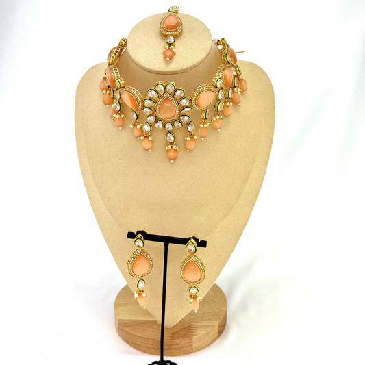 ﻿Choker set with peach, clear stones and peach beads.  Set includes choker, tikka and earrings.  Prefect for Indian weddings, parties and special occasions.  Latest 2022 fashion. High end Indian fashion jewellery with top quality stones and beads.