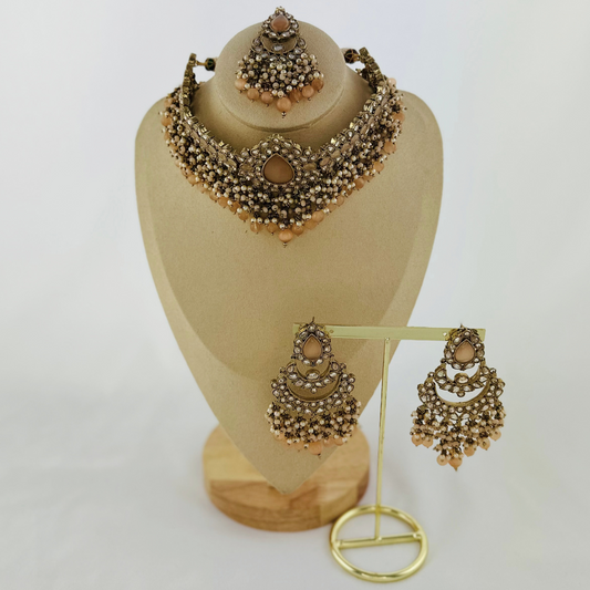 Choker set with peach beads and stones.  Set includes necklace, tikka & earrings.  Prefect for Indian weddings, parties and special occasions.   Latest 2023 fashion. High end Indian fashion jewellery with top quality stones and beads.