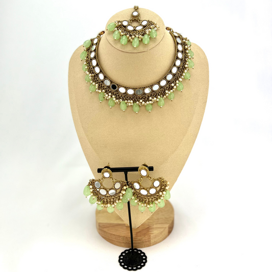 Mirror necklace set with green beads and small white pearls.  Set includes necklace, tikka and earrings.  Prefect for Indian parties, weddings and special occasions.   Latest 2022 fashion.