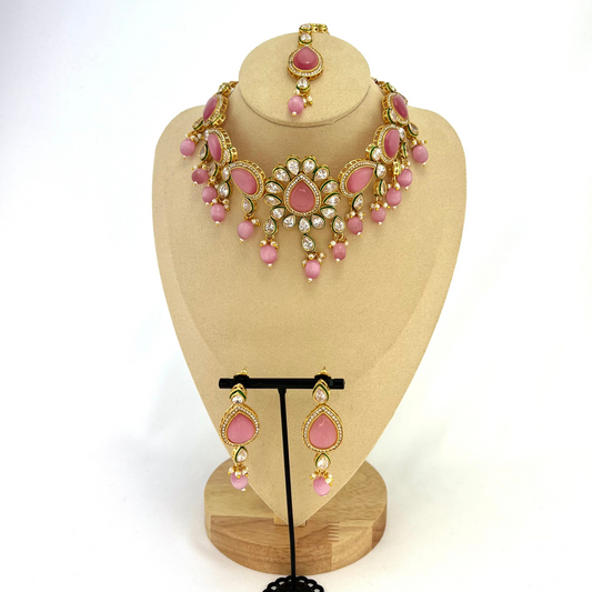 Choker set with pink, clear stones and pink beads. Set includes choker, tikka and earrings. Prefect for Indian weddings, parties and special occasions. Latest 2022 fashion. High end Indian fashion jewellery with top quality stones and beads.