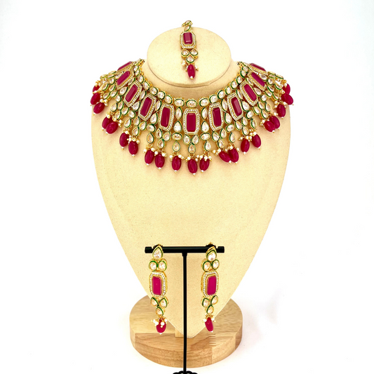 Necklace set with hot pink beads and clear and hot pink stones.  Set includes necklace, tikka and earrings.  Prefect for Indian weddings, parties and special occasions.  Latest 2022 fashion. High end Indian fashion jewellery with top quality stones and beads.