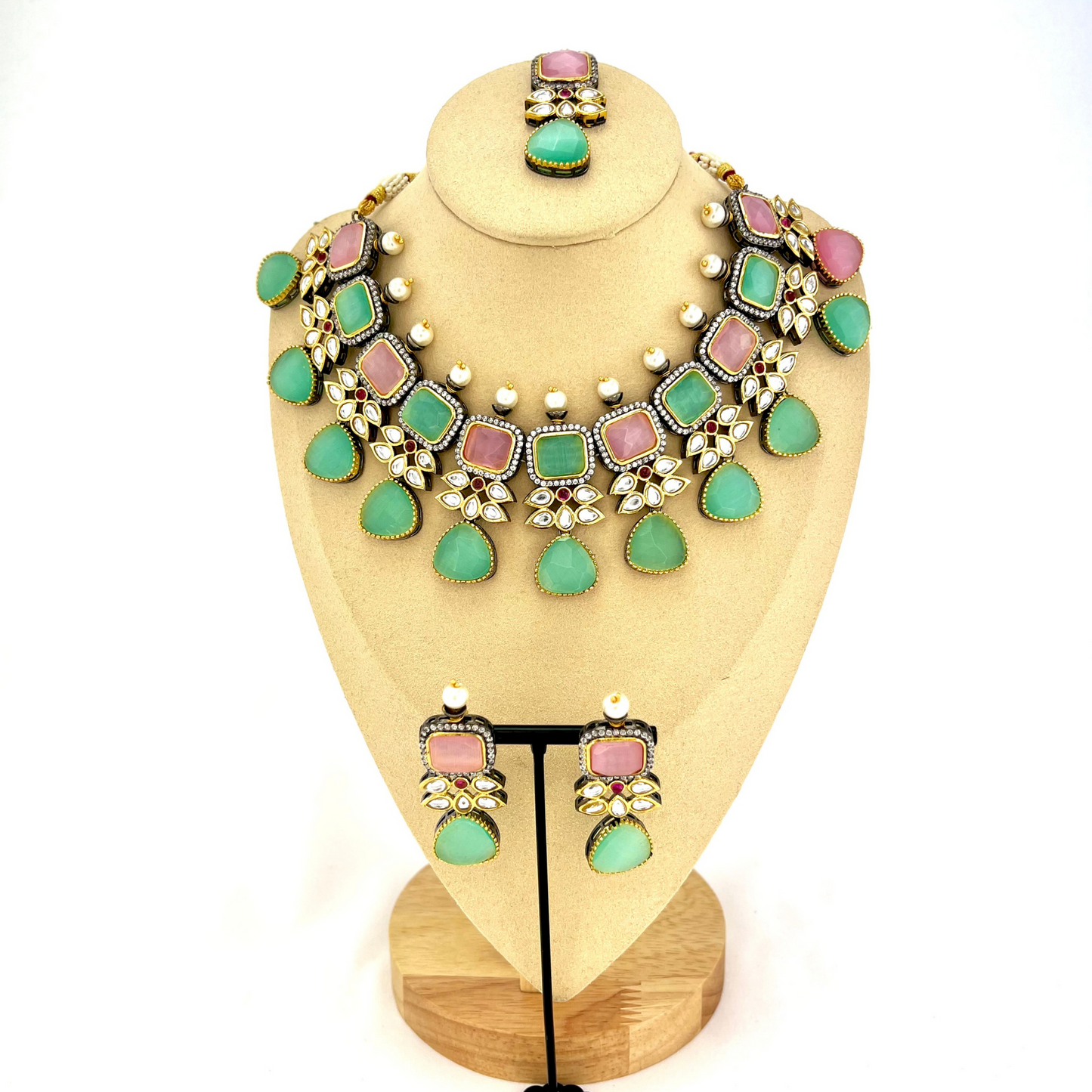 Necklace set with green, pink and silver stone work finished with small white pearls.  Set includes necklace, tikka and earrings.  Prefect for Indian parties, weddings and special occasions.   Latest 2022 fashion 