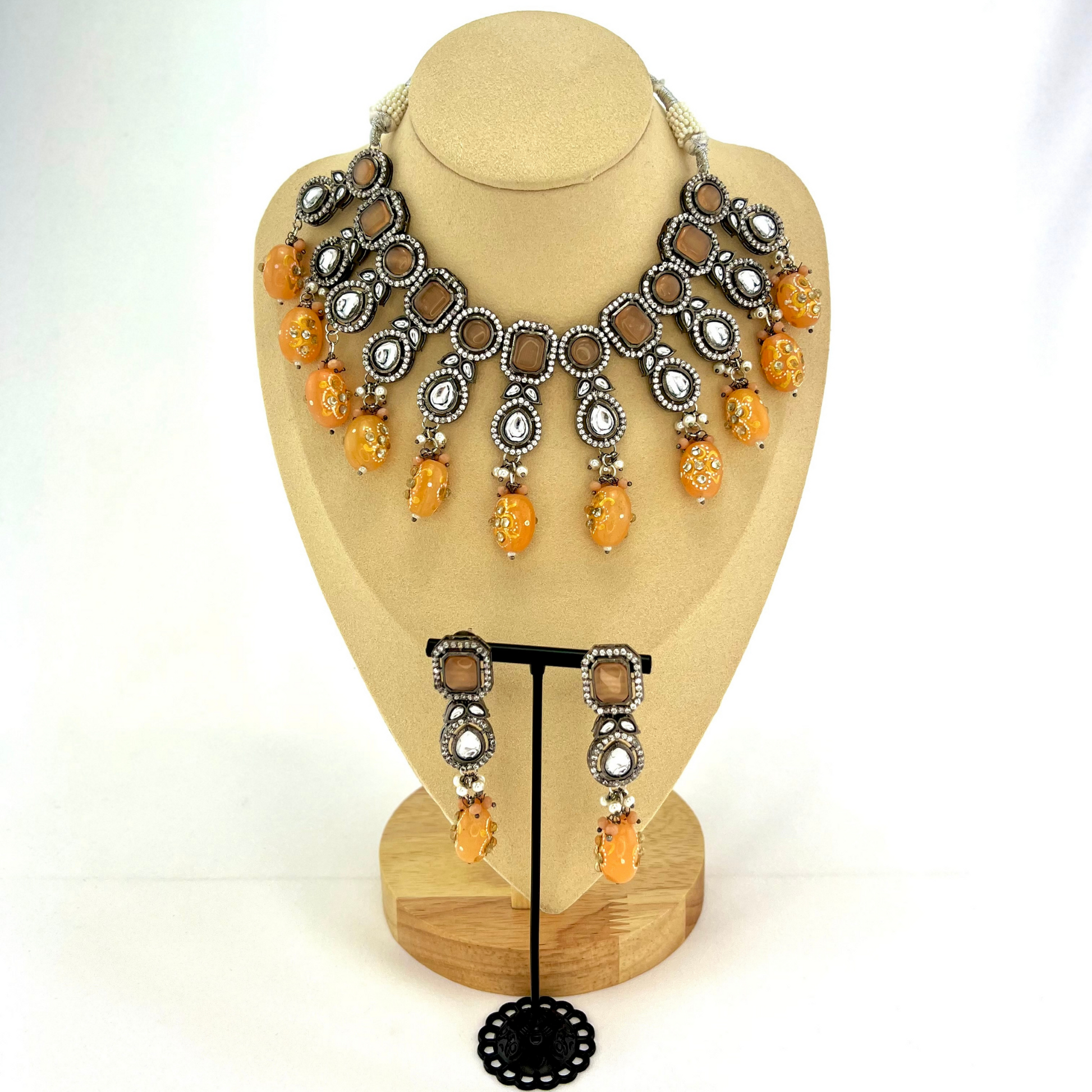 Kundan necklace set with peach and clear stone work.  Set includes necklace and earrings.  Prefect for Indian weddings, parties and special occasions.  Latest 2022 fashion. High end Indian fashion jewellery with top quality stones and beads.