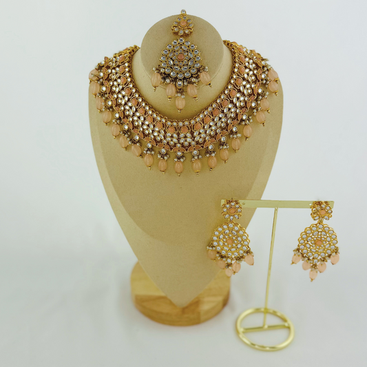 Necklace set with peach stones and beads.  Set includes necklace, tikka & earrings.  Prefect for Indian weddings, parties and special occasions.   Latest 2023 fashion. High end Indian fashion jewellery with top quality stones and beads.