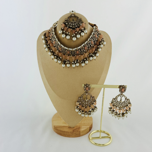 Necklace set with peach stones and white pearl beads.  Set includes necklace, tikka & earrings.  Prefect for Indian weddings, parties and special occasions.   Latest 2023 fashion. High end Indian fashion jewellery with top quality stones and beads.