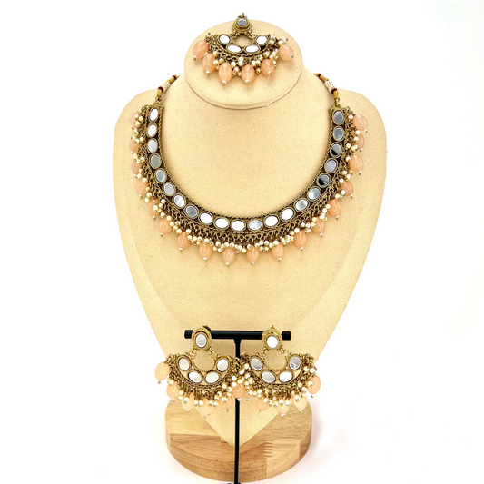 Mirror necklace set with peach beads and small white pearls.  Set includes necklace, tikka and earrings.  Prefect for Indian parties, weddings and special occasions.   Latest 2022 fashion.