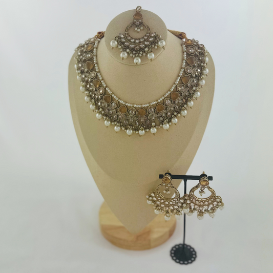 Necklace set with bronze stones and white pearl beads.  Set includes necklace, tikka & earrings.  Prefect for Indian weddings, parties and special occasions.   Latest 2023 fashion. High end Indian fashion jewellery with top quality stones and beads.