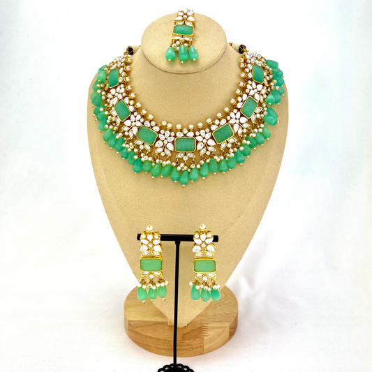 Necklace set with turquoise beads, clear and turquoise stones.  Set includes necklace, tikka & earrings.  Prefect for Indian weddings, parties and special occasions.   Latest 2022 fashion. High end Indian fashion jewellery with top quality stones and beads.