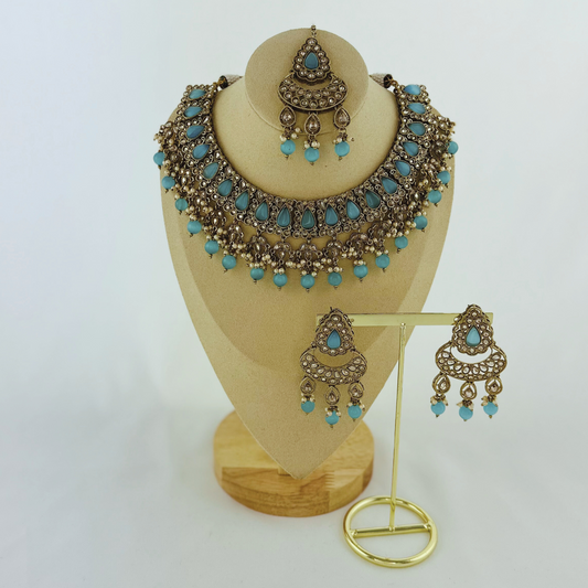 Necklace set with blue stones and beads.  Set includes necklace, tikka & earrings.  Prefect for Indian weddings, parties and special occasions.   Latest 2023 fashion. High end Indian fashion jewellery with top quality stones and beads.