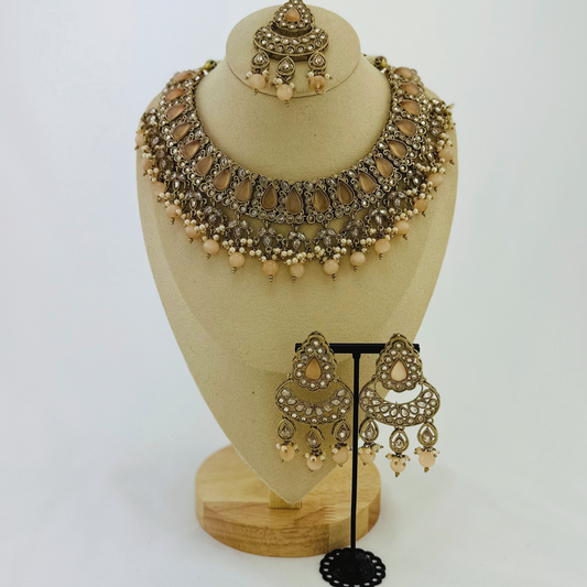 Necklace set with peach beads and stone.  Set includes necklace, tikka & earrings.  Prefect for Indian weddings, parties and special occasions.   Latest 2023 fashion. High end Indian fashion jewellery with top quality stones and beads.