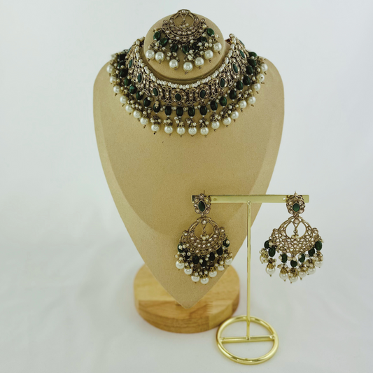 Necklace set with green stones and white pearl beads.  Set includes necklace, tikka & earrings.  Prefect for Indian weddings, parties and special occasions.   Latest 2023 fashion. High end Indian fashion jewellery with top quality stones and beads.